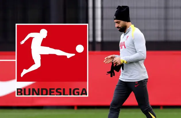 Mo Salah takes off his gloves during a Liverpool training session.