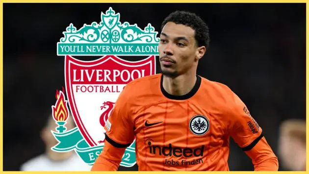 Hugo Ekitike runs on the pitch in front of Liverpool club crest.