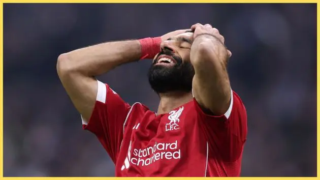 Mo Salah slaps his hands on his forehead in disbelief.