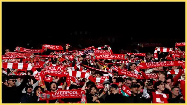 Fans of Liverpool hold their scarves aloft prior to the Premier League match between Liverpool and West Ham United at Anfield