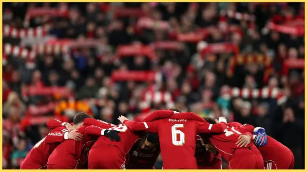 Liverpool players form a huddle prior to kick-off
