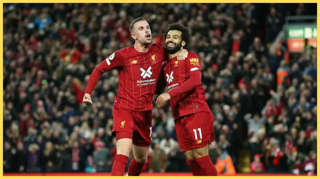 Mohamed Salah of Liverpool (11) celebrates as he scores his team's second goal from a penalty with Jordan Henderson during the Premier League match between Liverpool FC and Tottenham Hotspur at Anfield