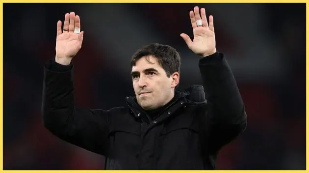 Liverpool manager Andoni Iraola holds his hands up in the air.