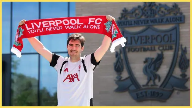 Liverpool manager Andoni Iraola smiles and holds up a LFC scarf outside the AXA training centre.