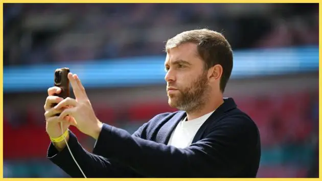 Transfer news expert Fabrizio Romano texts on his phone.