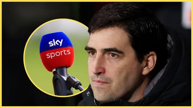 Liverpool manager Andoni Iraola looks on next to Sky Sports microphone.
